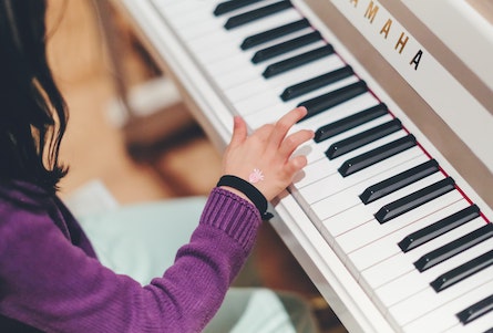 Girl learning the piano